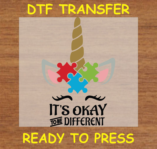 "It's Okay to Be Different DTF Transfer featuring a unicorn and colorful puzzle pieces design"