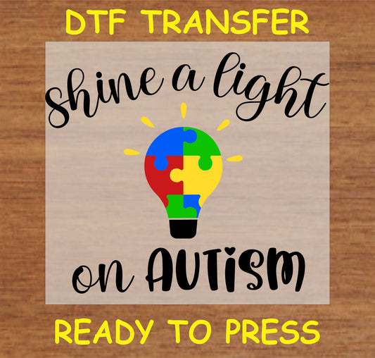 "Shine a Light on Autism DTF Transfer with colorful puzzle piece lightbulb design"