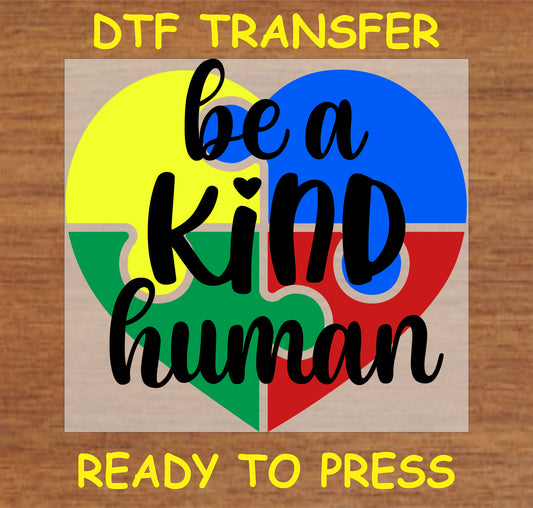 "Be a Kind Human DTF Transfer with colorful puzzle heart design for promoting kindness"