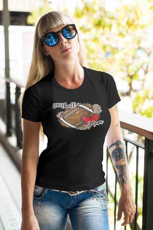 Black T-shirt with 'Football Mom' graphic, featuring a leopard print background, football design, and red heart.