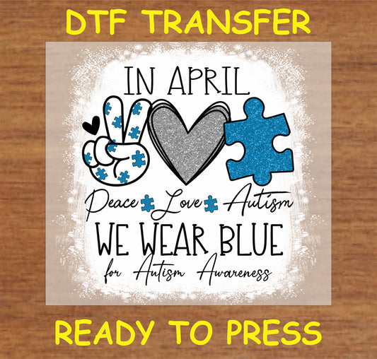 "In April We Wear Blue DTF Transfer with glitter heart and puzzle pieces promoting autism awareness"