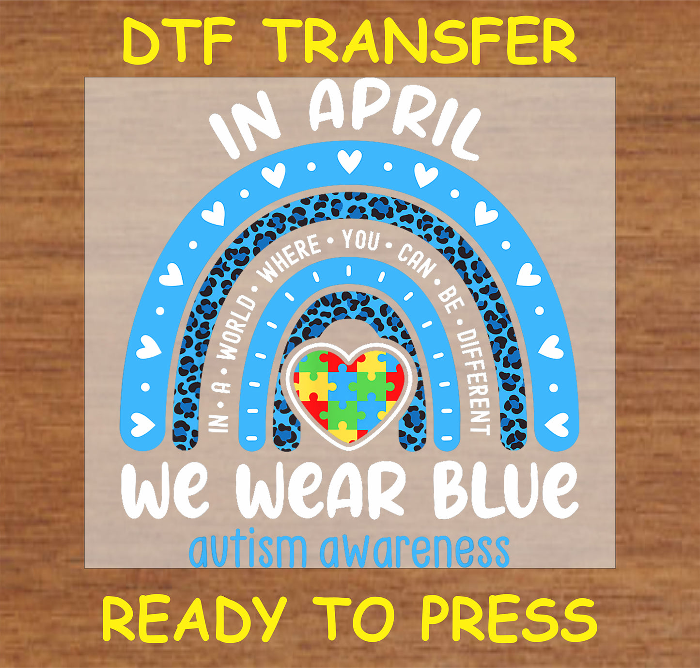 "In April We Wear Blue Autism Awareness DTF Transfer with rainbow and puzzle heart design"