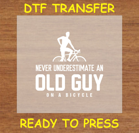 "Never Underestimate an Old Guy on a Bicycle DTF Transfer with confident cyclist silhouette"