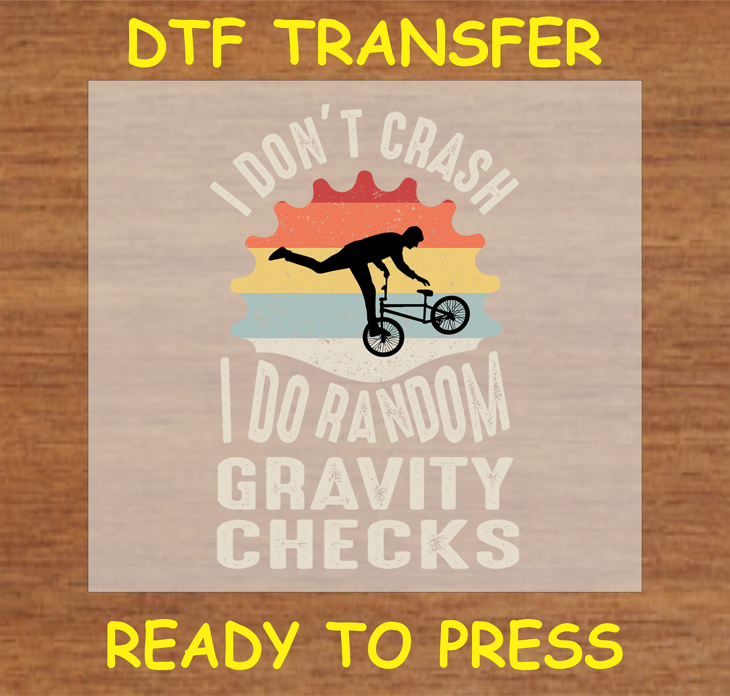 "Gravity Checks DTF Transfer with humorous cycling design and vintage sunset background"