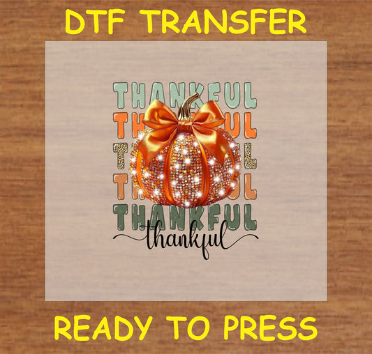 "Thankful Pumpkin DTF Transfer with sparkling orange pumpkin, bow, and 'Thankful' text for Thanksgiving decor and fall apparel"