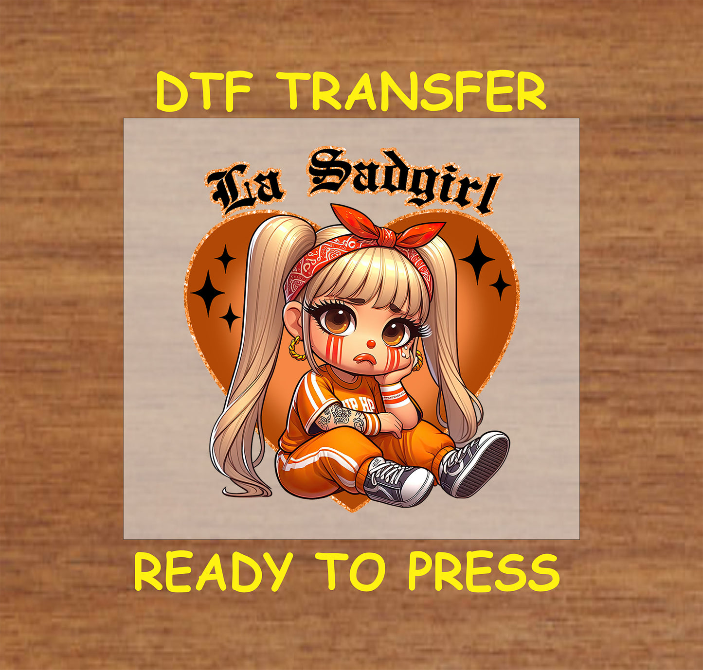 “La Sadgirl” ready to press DTF transfer! This cute design features the text "La Sadgirl" with sad Chicano character with a orange heart accent.