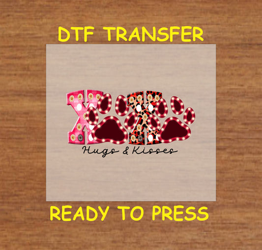 “Hugs & Kisses” DTF transfer! This vibrant design features the text "Hugs & Kisses" with Paw prints in multi print. 