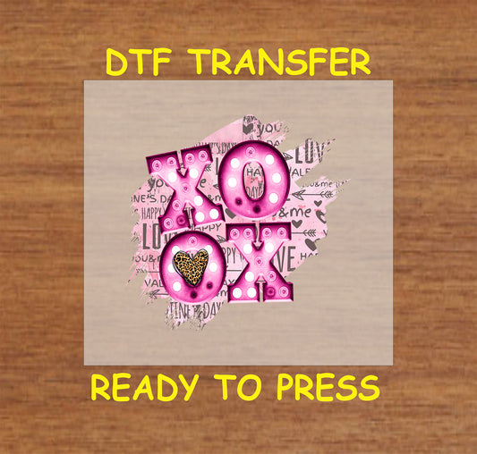 "XOXO leopard heart DTF transfer in pink with polka dots and Valentine-themed background, ready-to-press for apparel and crafts."