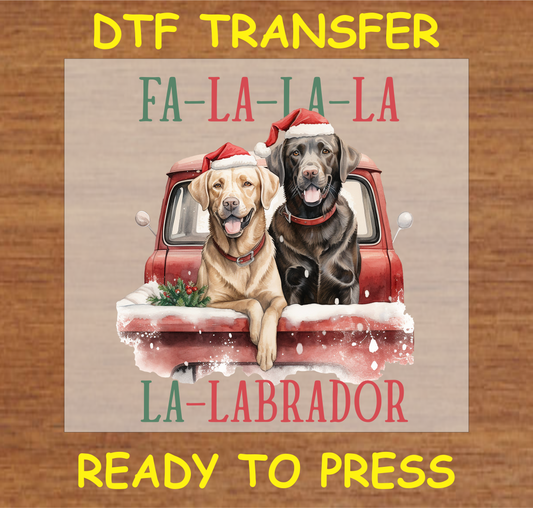 Two Labradors in Santa hats riding in a red holiday truck with the text "Fa-La-La-La Labrador" DTF transfer.