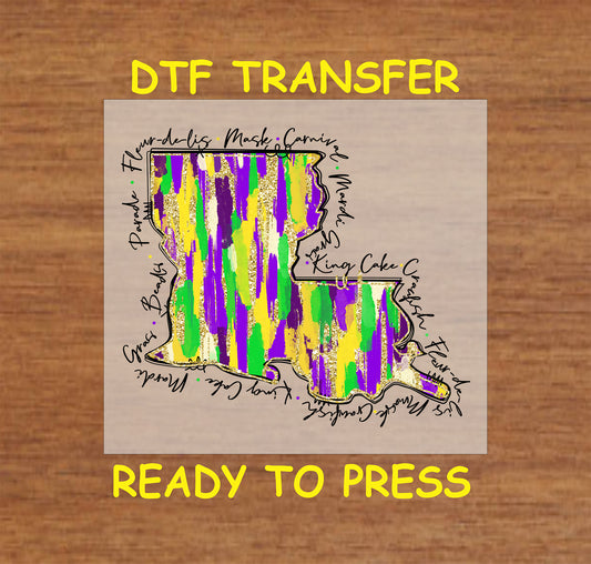 DTF transfer featuring a Louisiana map in Mardi Gras colors with themed words like "King Cake," "Fleur-de-lis," and "Beads" surrounding the design.