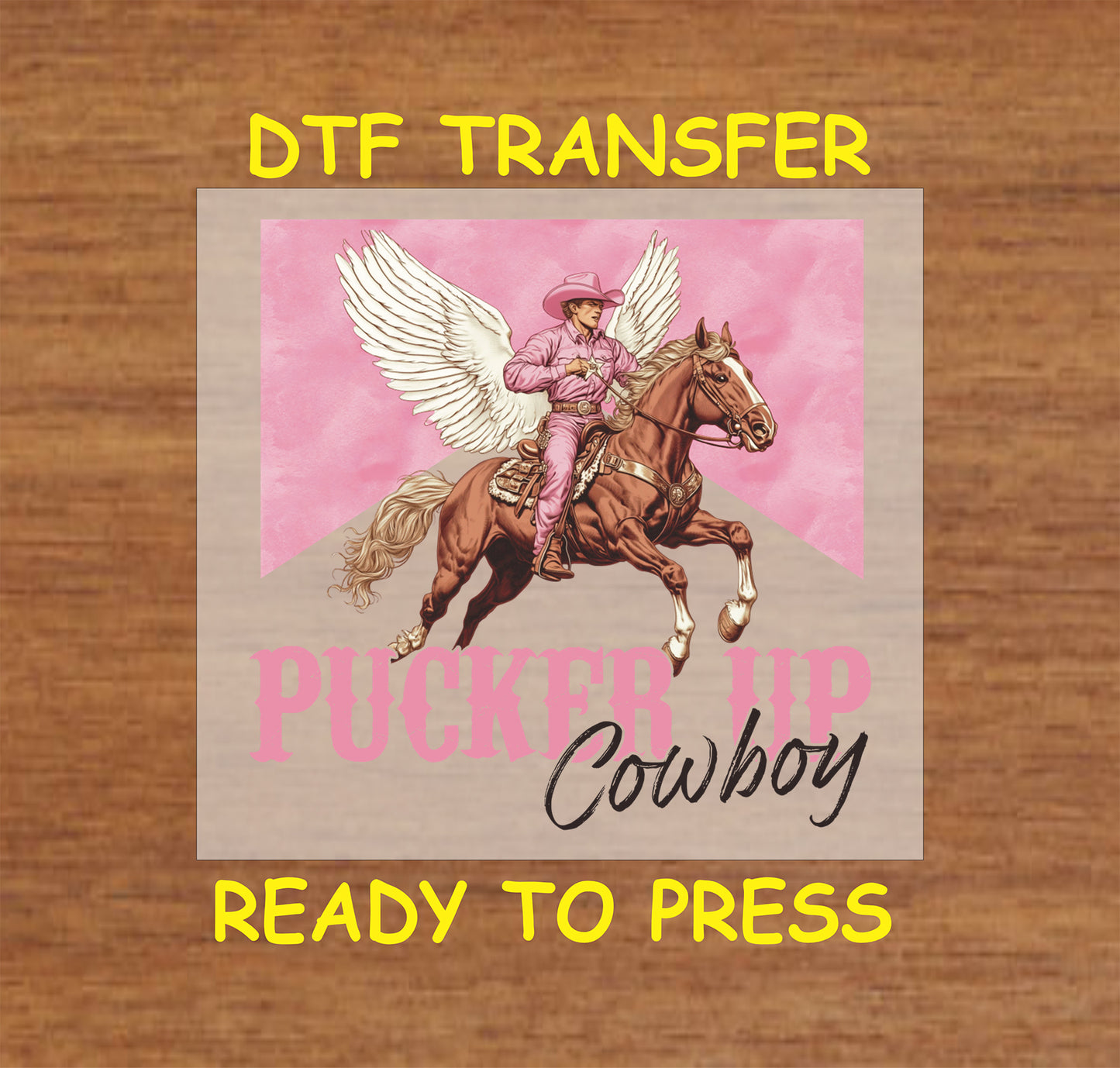 DTF transfer featuring a cowboy in pink riding a horse with angel wings and the text "Pucker Up Cowboy" on a pink background.

