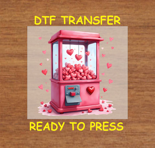 Valentine's Day-themed DTF transfer featuring a pink claw machine filled with hearts and floating heart accents, perfect for DIY apparel.