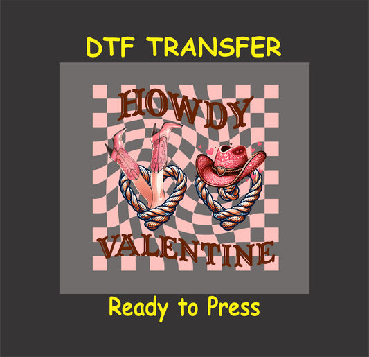 Howdy Valentine DTF Transfer with pink cowboy boots, hat, heart-shaped rope, and checkered pink background for Western Valentine crafts.