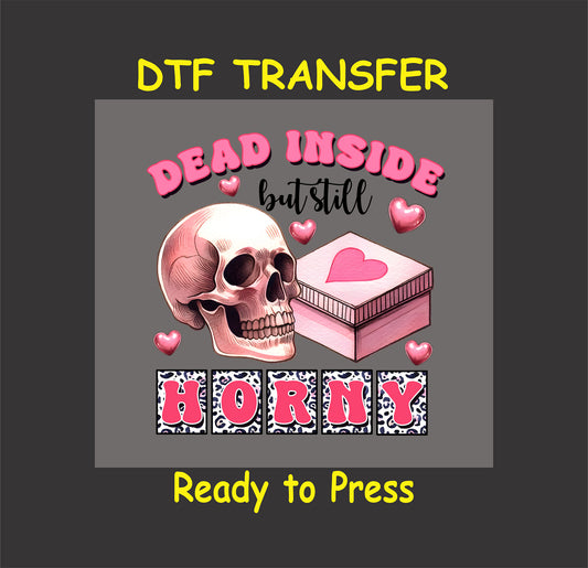 Skull with a pink heart box, surrounded by pink hearts and text reading "Dead Inside But Still Horny."