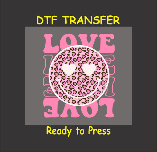 Valentine’s Day DTF transfer with a leopard-print smiley face and heart eyes surrounded by bold pink "LOVE" text.