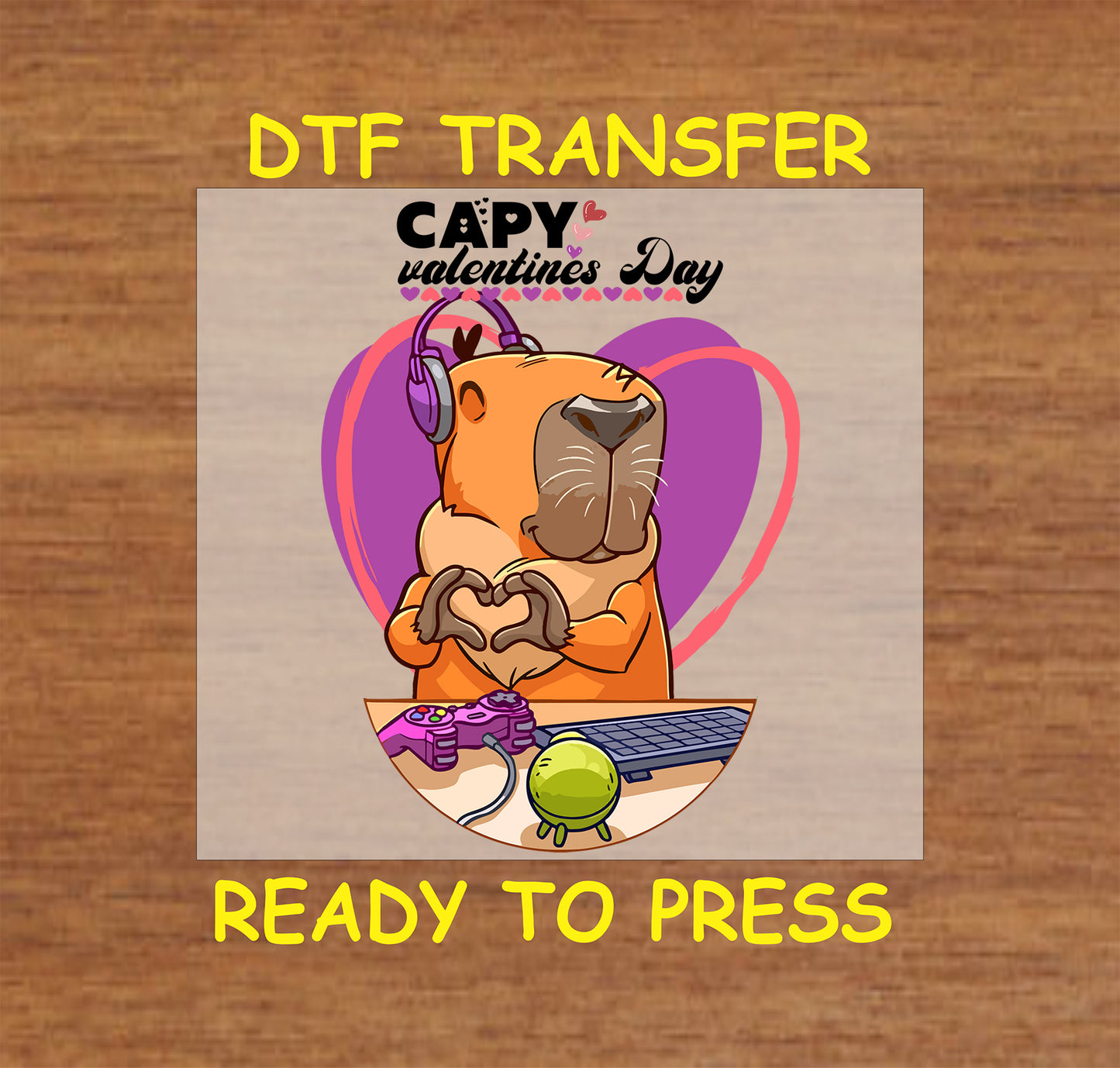 "DTF transfer of a capybara wearing headphones and forming a heart with its hands, featuring a gaming setup and a Valentine’s Day heart background."