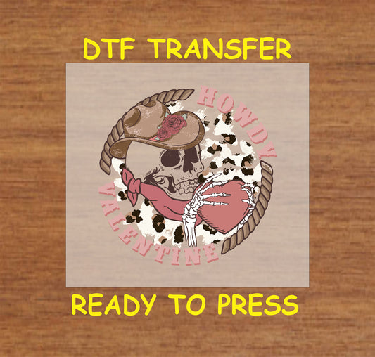 Western Valentine DTF transfer with a cowboy skull, rope heart, and "Howdy Valentine" text on a cow print background.