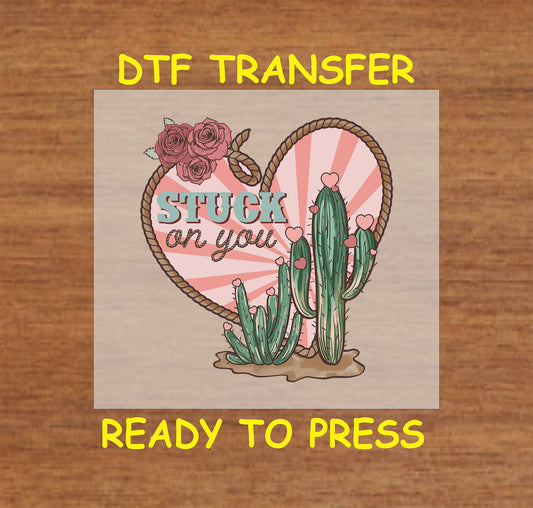 Western Valentine's DTF transfer with "Stuck on You" text, heart-shaped rope, and blooming cacti.