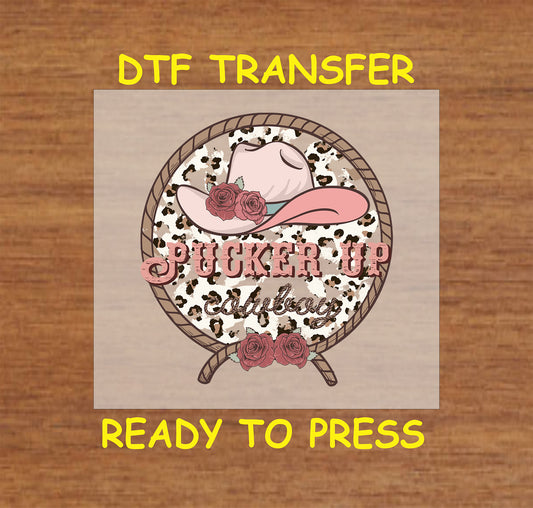 Western Valentine DTF transfer with "Pucker Up Cowboy" text, pink cowboy hat, roses, and rope border.