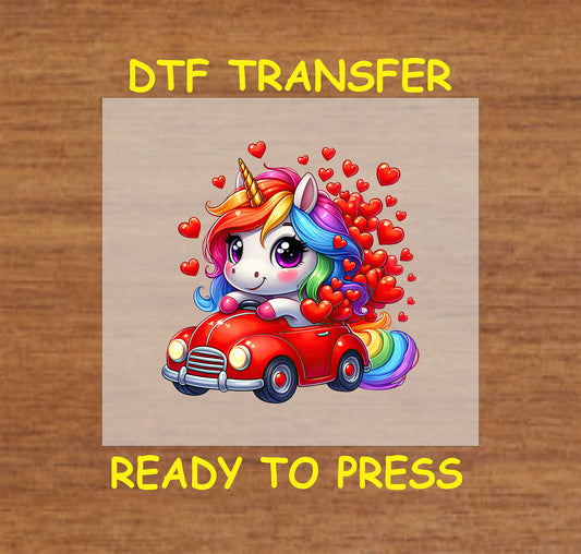 Cute rainbow unicorn in a red car with hearts DTF transfer.