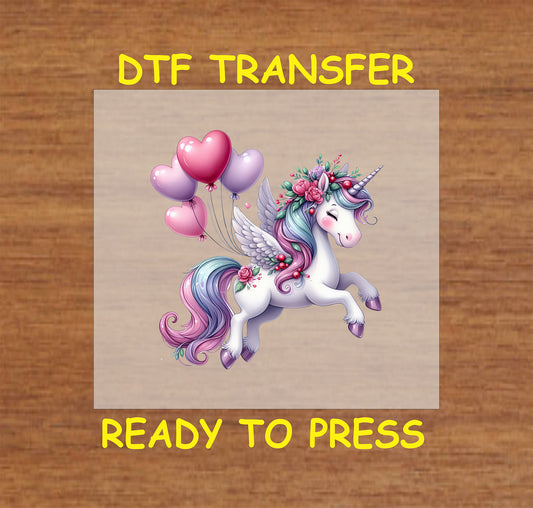 Winged unicorn with floral accents and heart balloons DTF transfer.