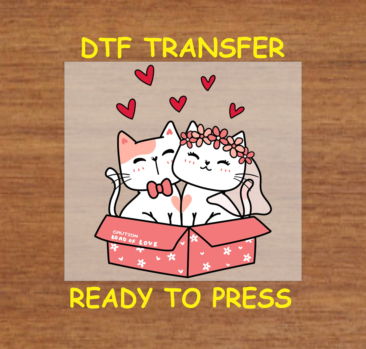 Two romantic cats dressed as a bride and groom inside a decorated box with floating hearts.