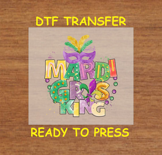 Mardi Gras King DTF transfer with colorful text, masquerade mask, feathers, and beads in purple, green, and gold.