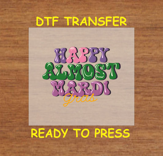 DTF transfer with colorful text reading "Happy Almost Mardi Gras."