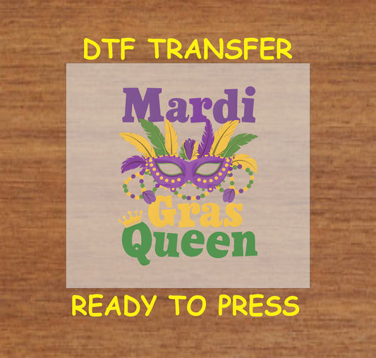 DTF transfer with "Mardi Gras Queen" text and a masquerade mask with feathers and beads.