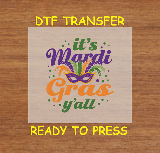 DTF transfer with "It’s Mardi Gras Y’all" text, masquerade mask, feathers, and festive accents.