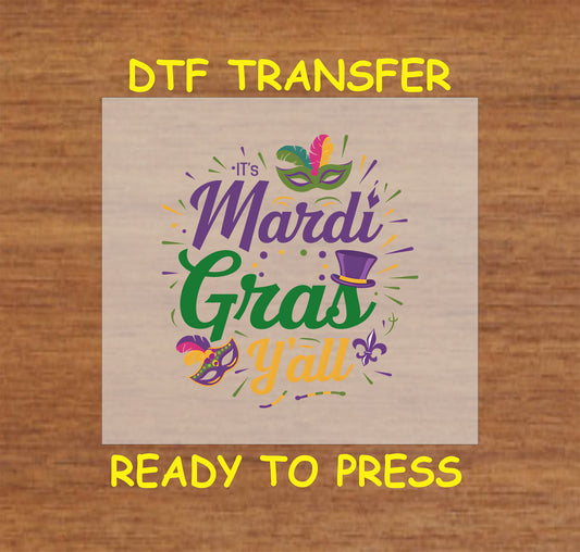 DTF transfer with colorful Mardi-themed lettering, masks, feathers, and festive accents.