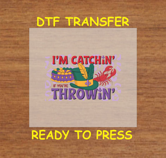 Mardi Gras DTF transfer with a top hat, king cake, crawfish, and text reading "I’m Catchin’ If You’re Throwin’."