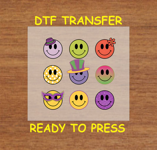 Mardi Gras DTF transfer with smiley faces in festive colors, masks, and hats.