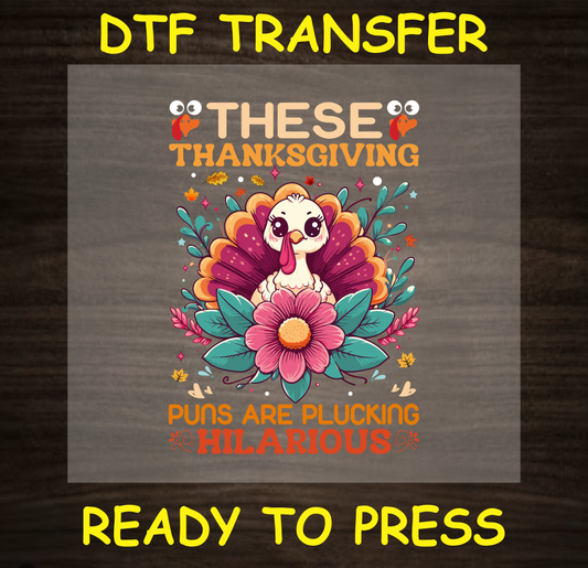 DTF transfer design featuring an adorable turkey surrounded by colorful flowers and the text 'These Thanksgiving Puns Are Plucking Hilarious'.