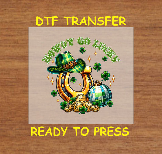 St. Patrick’s Day-themed DTF transfer featuring a horseshoe, cowboy hat, disco ball, and shamrocks with "Howdy Go Lucky" text.