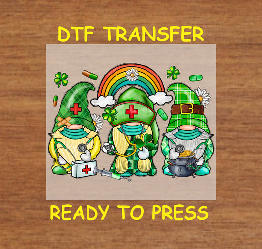 St. Patrick’s Day DTF transfer with nurse gnomes, clovers, a rainbow, and medical elements.