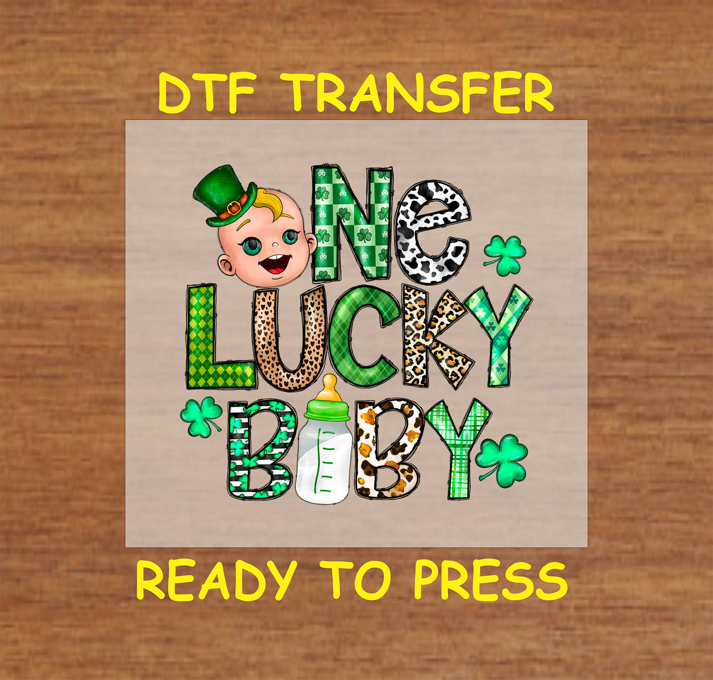 St. Patrick’s Day DTF transfer with "One Lucky Baby" text, baby face, bottle, and shamrocks.