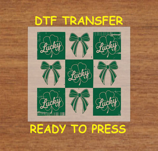 St. Patrick’s Day patch-style DTF transfer with shamrocks, bows, and "Lucky" text.