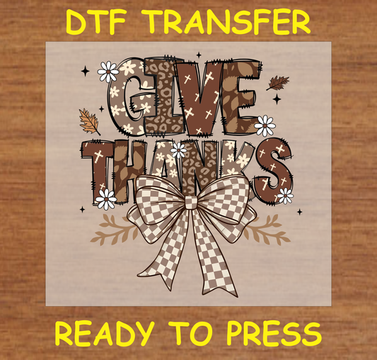 "Give Thanks" DTF transfer design features warm autumnal tones, an elegant plaid bow, and a delightful mix of patterns spelling out "Give Thanks."