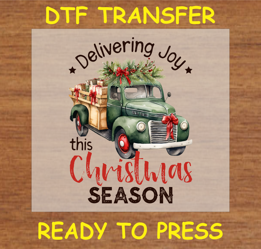 "Delivering Joy DTF Transfer featuring a vintage green truck with Christmas gifts and festive greenery design"