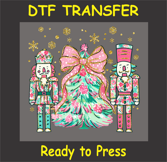 "Nutcracker Christmas DTF Transfer with colorful nutcracker soldiers and a Christmas tree wrapped in a pink bow and lights"