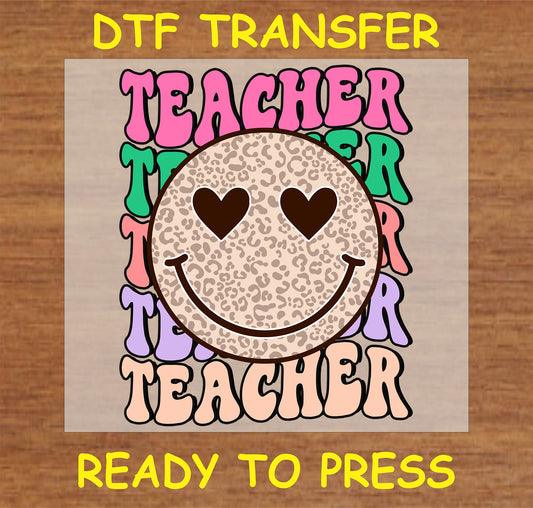 "Teacher DTF Transfer with a leopard print smiley face and heart eyes on a colorful retro background"