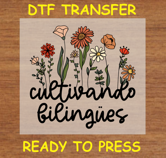 Cultivando Bilingües' DTF Transfer design featuring a collection of wildflowers with the phrase 'Cultivando Bilingües' in elegant script. Ready to press