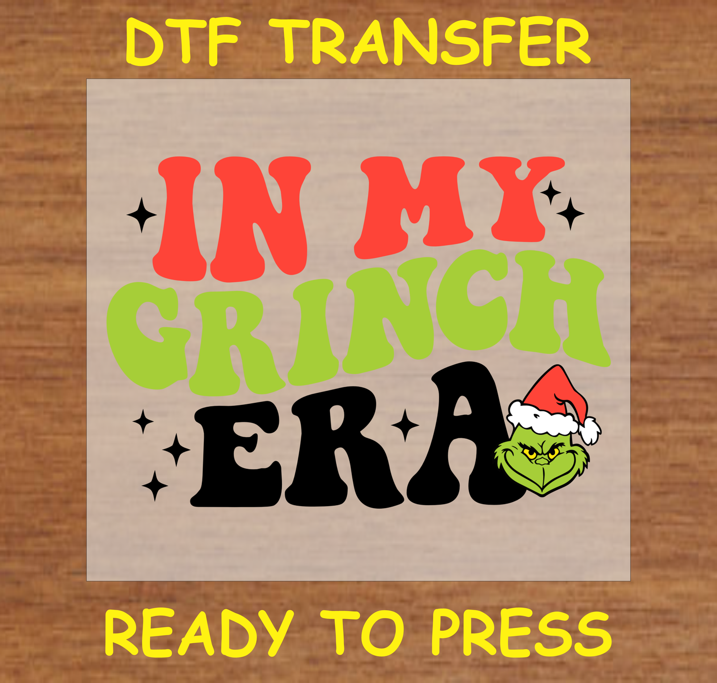 DTF transfer featuring bold, colorful text with the phrase "In My Green Grumpy Character Era" alongside a Iconic Christmas Character wearing a Santa hat.