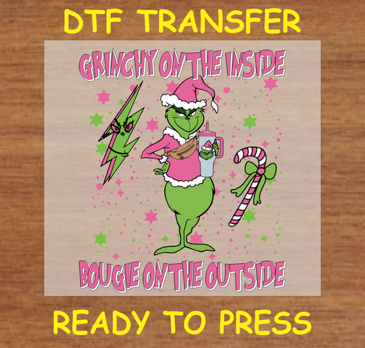 DTF transfer featuring the Iconic Christmas character in a Santa hat holding a drink and wearing stylish accessories.