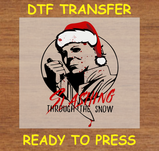 DTF transfer featuring a horror-themed character in a Santa hat with the phrase "Slashing Through the Snow."