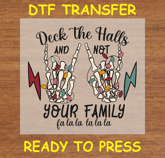 DTF transfer design featuring two skeleton hands wrapped in colorful Christmas lights with the text "Deck the Halls and Not Your Family."